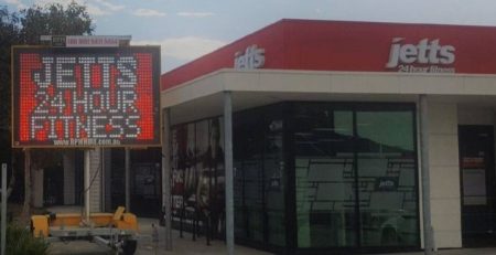 Variable Message Sign promoting a color message for Jetts Gym